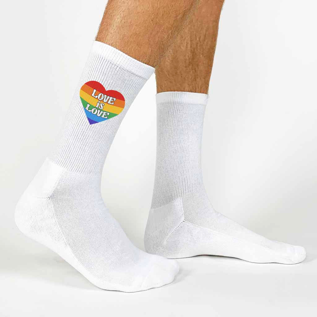 Love is love rainbow heart design custom printed on comfy white cotton crew socks for your LGBTQ pride friends.