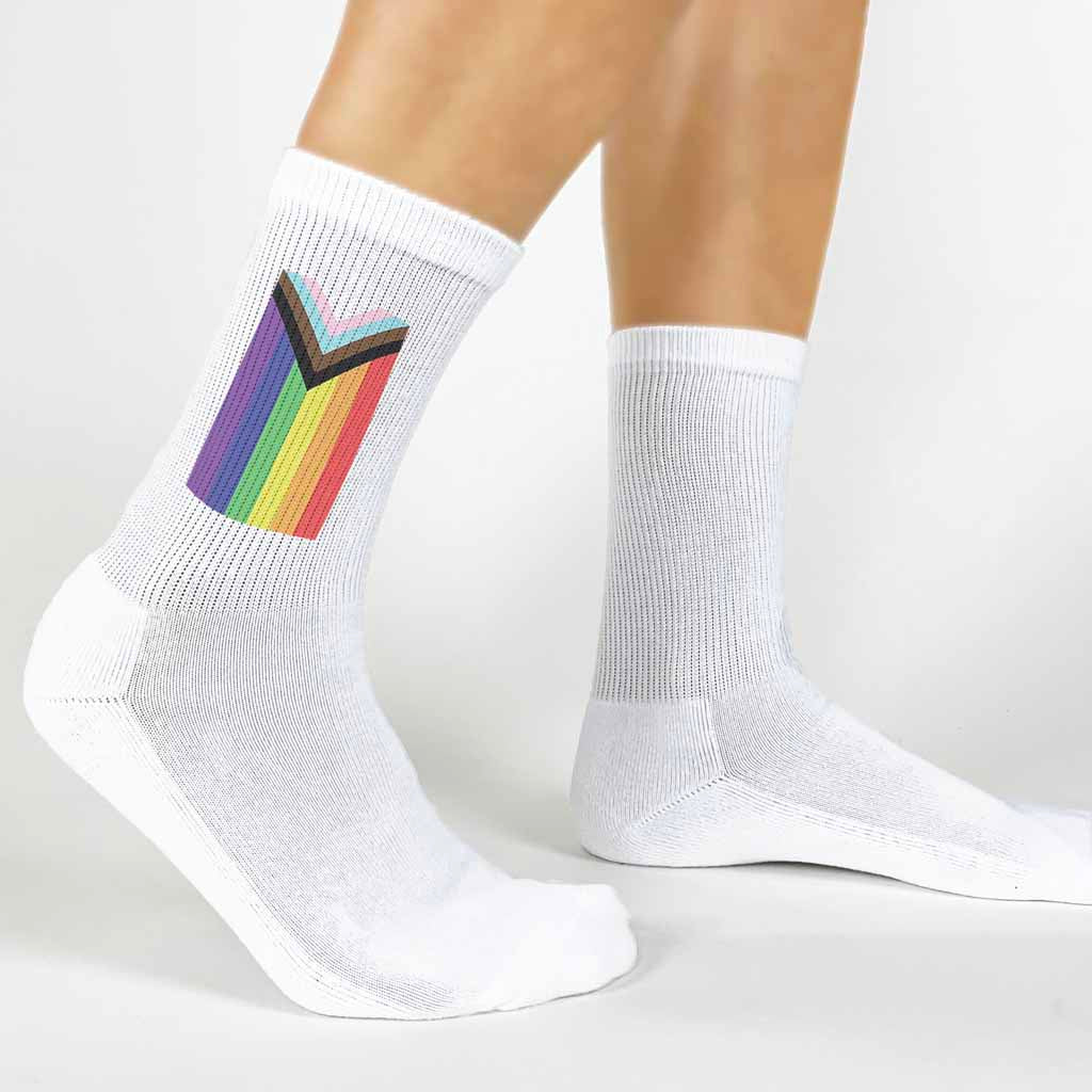 Show your pride and support for the LGBTQ community with these stylish and comfortable socks digitally printed with the progress pride flag.