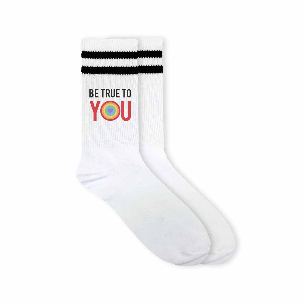 Be true to you rainbow heart design custom printed on white cotton crew socks with black stripes make the perfect accessory for pride month.