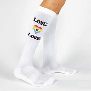 Love is love rainbow heart design custom printed on white cotton knee high socks are the perfect gift for all of your LGBTQ friends to wear for pride month.