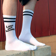 Loud and proud design digitally printed in black ink on the outsides of white cotton crew socks with black stripes make the perfect gift for your LGBTQ pride friends.