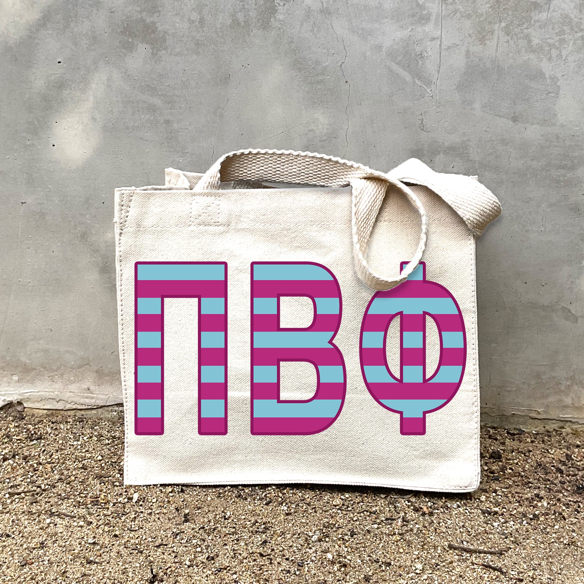 PBP Black Stripe Tote in front of a gray wall