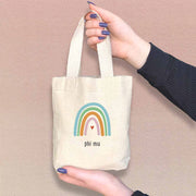 Phi Mu sorority name rainbow design digitally printed on natural mini tote gift bag.