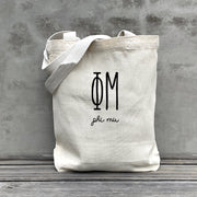 Phi Mu lifestyle image of a Phi Mu tote bag hanging on a dorm door, styled with the sorority’s name in retro font.