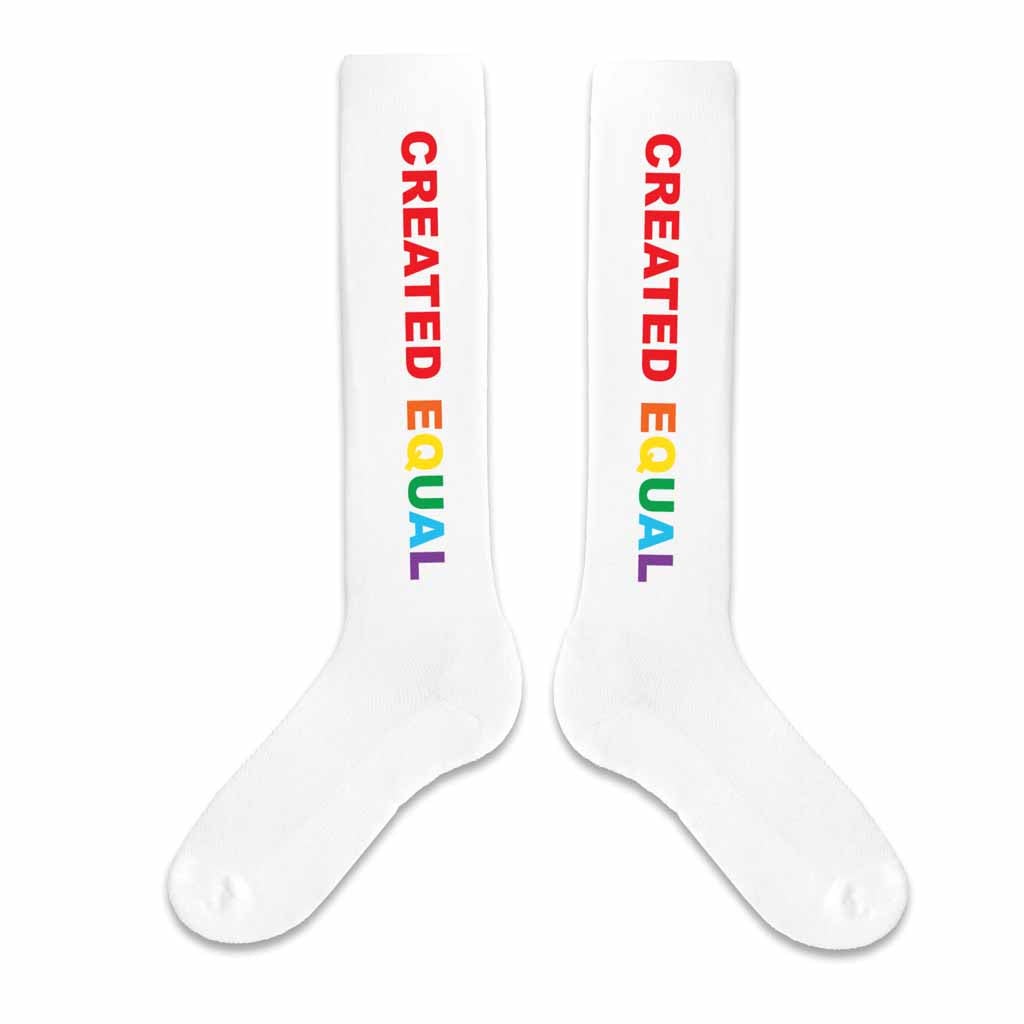 Created Equal rainbow printed design on white cotton knee high socks are perfect for LGBTQ gay pride celebrations.