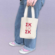 Sigma Kappa sorority letters in sorority colors digitally printed on the perfect mini size natural canvas tote bag.