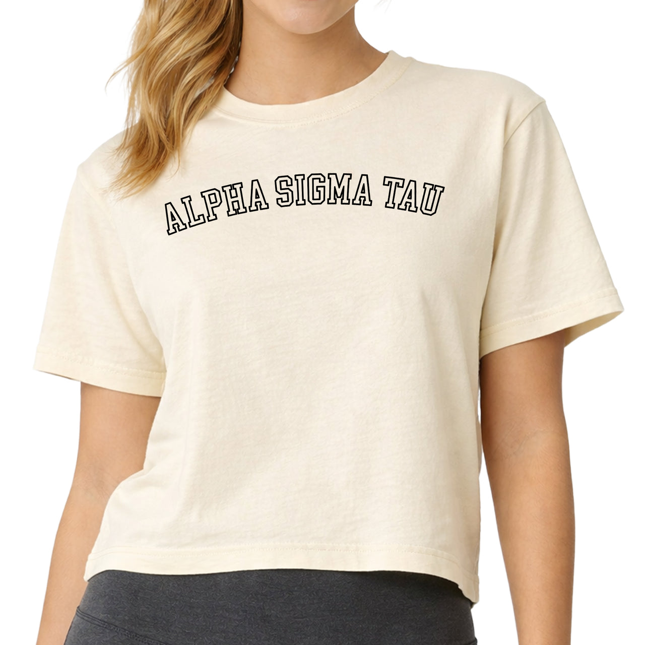 Woman wearing an Alpha Sigma Tau Comfort Colors boxy crop t-shirt featuring the sorority name in block letters 