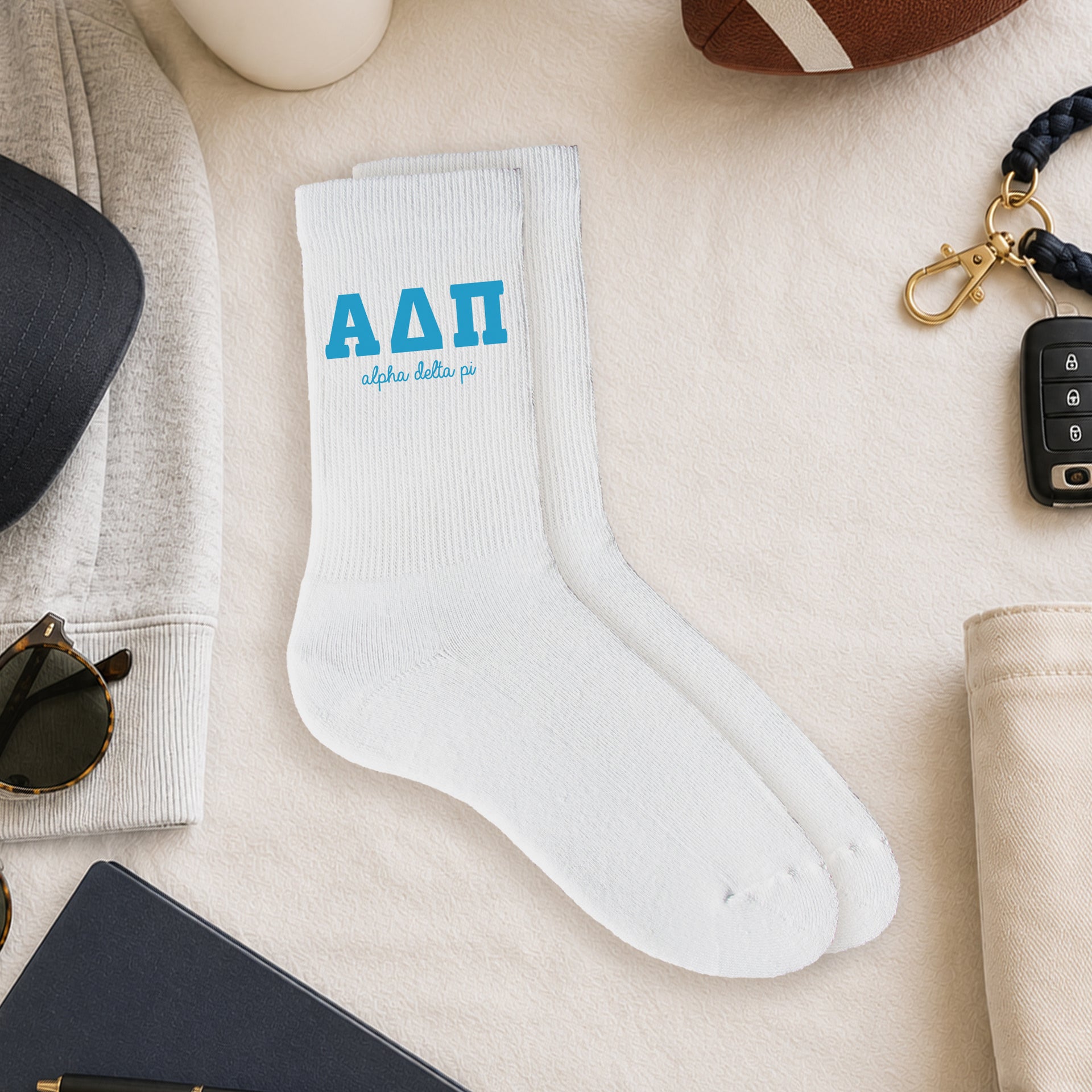 Alpha Delta Pi crew socks styled in a sorority flat lay with Greek life accessories and campus-inspired décor