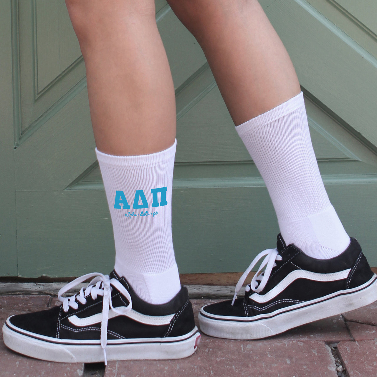 Alpha Delta Pi sorority member wearing white crew socks featuring Alpha Delta Pi Greek letters and sorority name