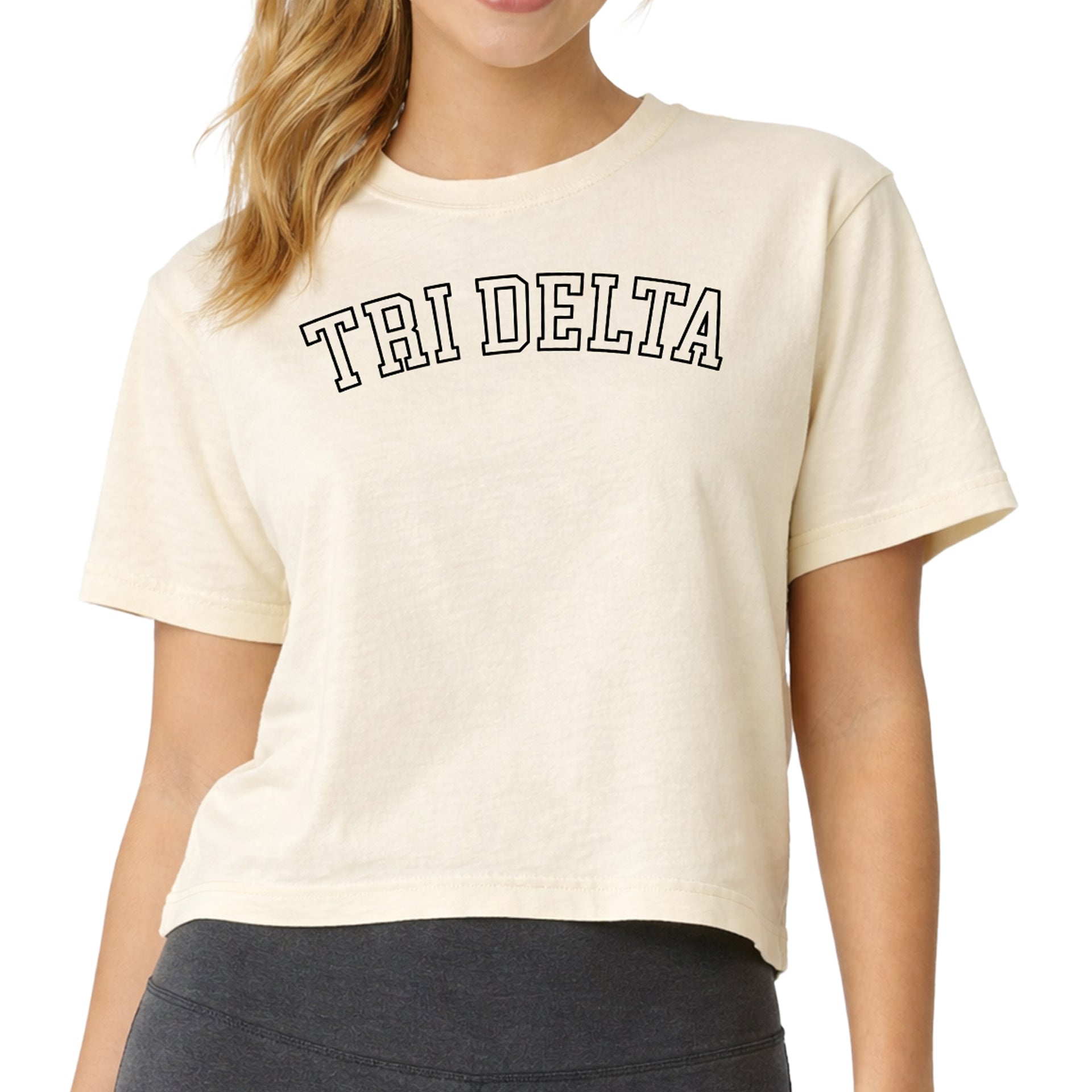 Delta Delta Delta woman wearing an officially licensed Comfort Colors boxy crop t-shirt featuring the Tri Delta sorority nickname design