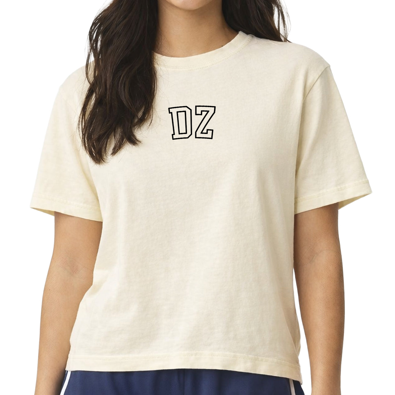 Woman wearing a Delta Zeta Comfort Colors boxy crop t-shirt featuring the sorority name in block letters 