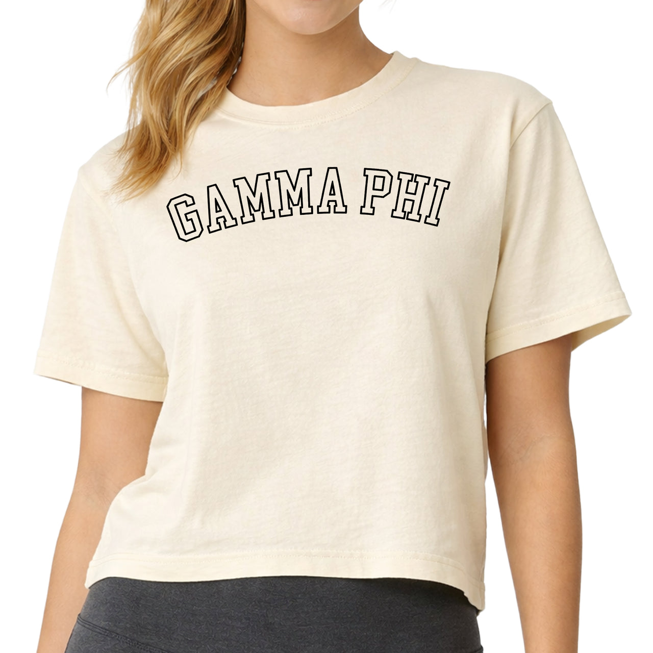 Woman wearing a Gamma Phi Beta Comfort Colors boxy crop t-shirt featuring the sorority name in block letters 