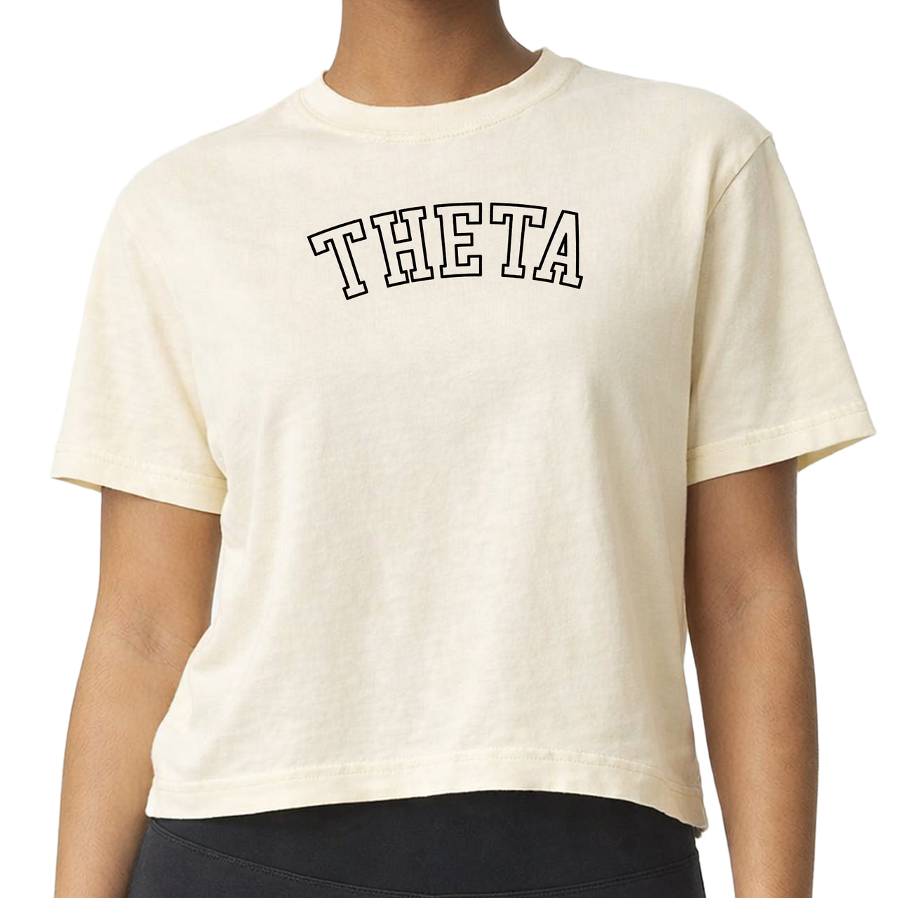 Woman wearing a Kappa Alpha Theta Comfort Colors boxy crop t-shirt featuring the sorority name in block letters 