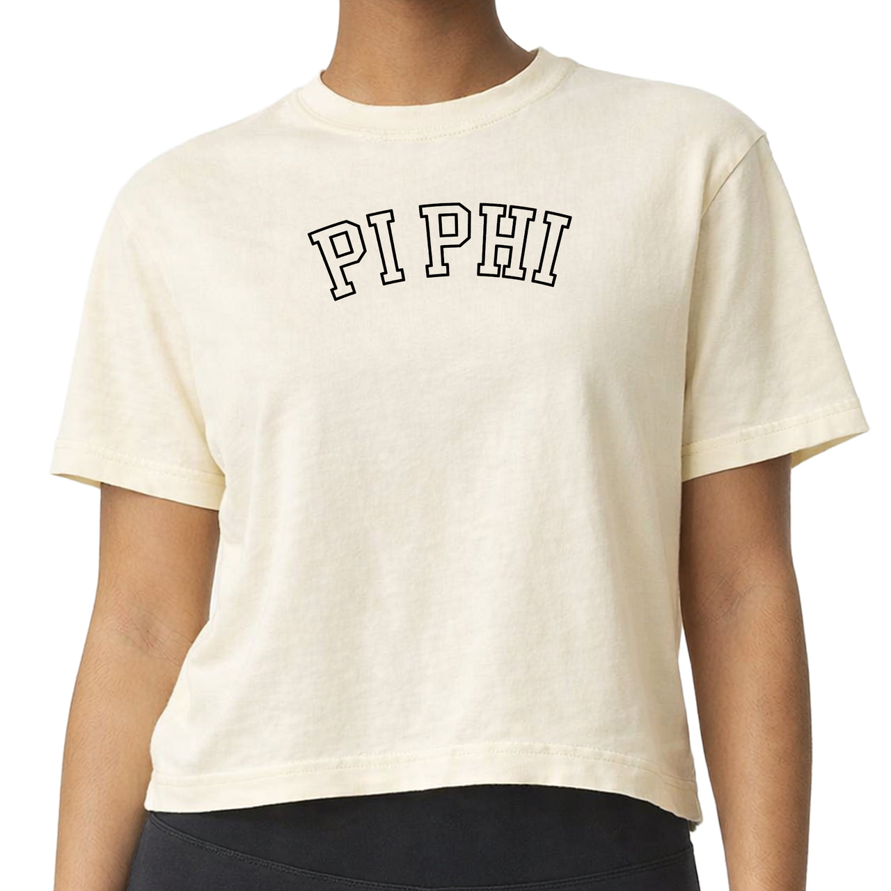 Woman wearing a Pi Beta Phi Comfort Colors boxy crop t-shirt featuring the sorority name in block letters 
