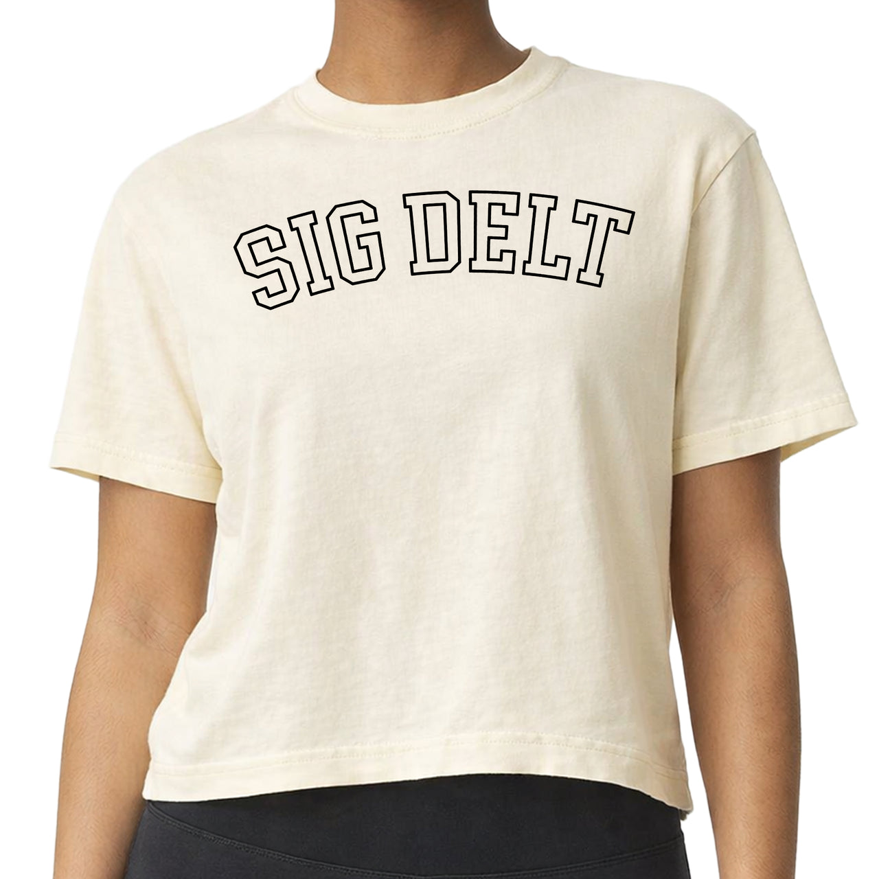 Woman wearing a Sigma Delta Tau Comfort Colors boxy crop t-shirt featuring the sorority name in block letters 