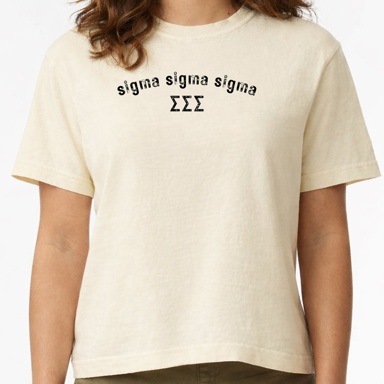 Woman wearing a Sigma Sigma Sigma Comfort Colors boxy crop t-shirt featuring the sorority name and Greek letters design