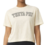 Theta Phi Alpha woman wearing an officially licensed Comfort Colors boxy crop t-shirt featuring the Theta Phi sorority nickname design