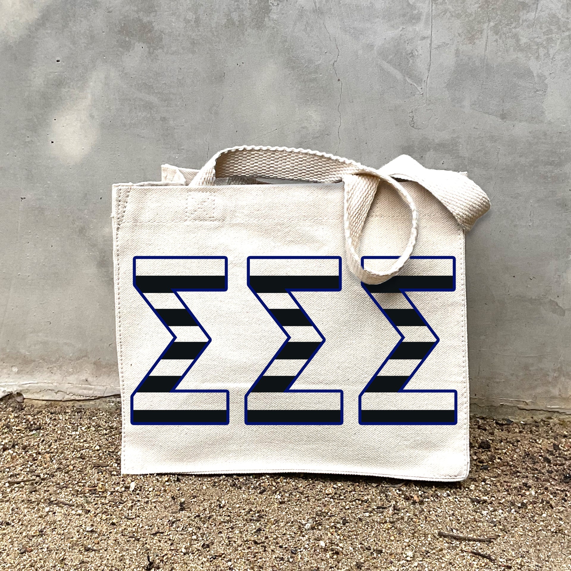 Model carrying the Sigma Sigma Sigma small black and white stripe tote.
