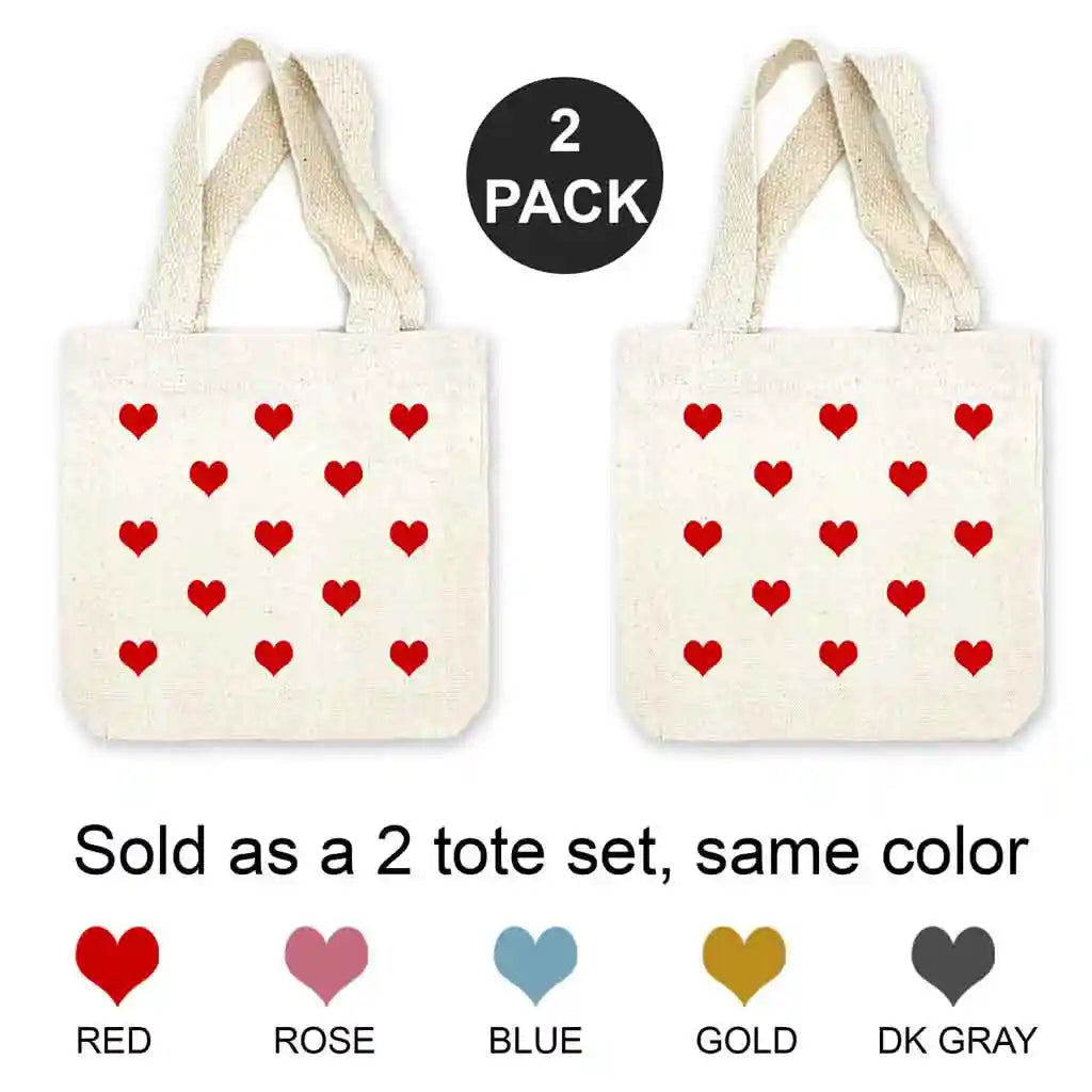 Mini canvas tote bags with all over heart design digitally printed in the color of your choice sold in a pack of four. 