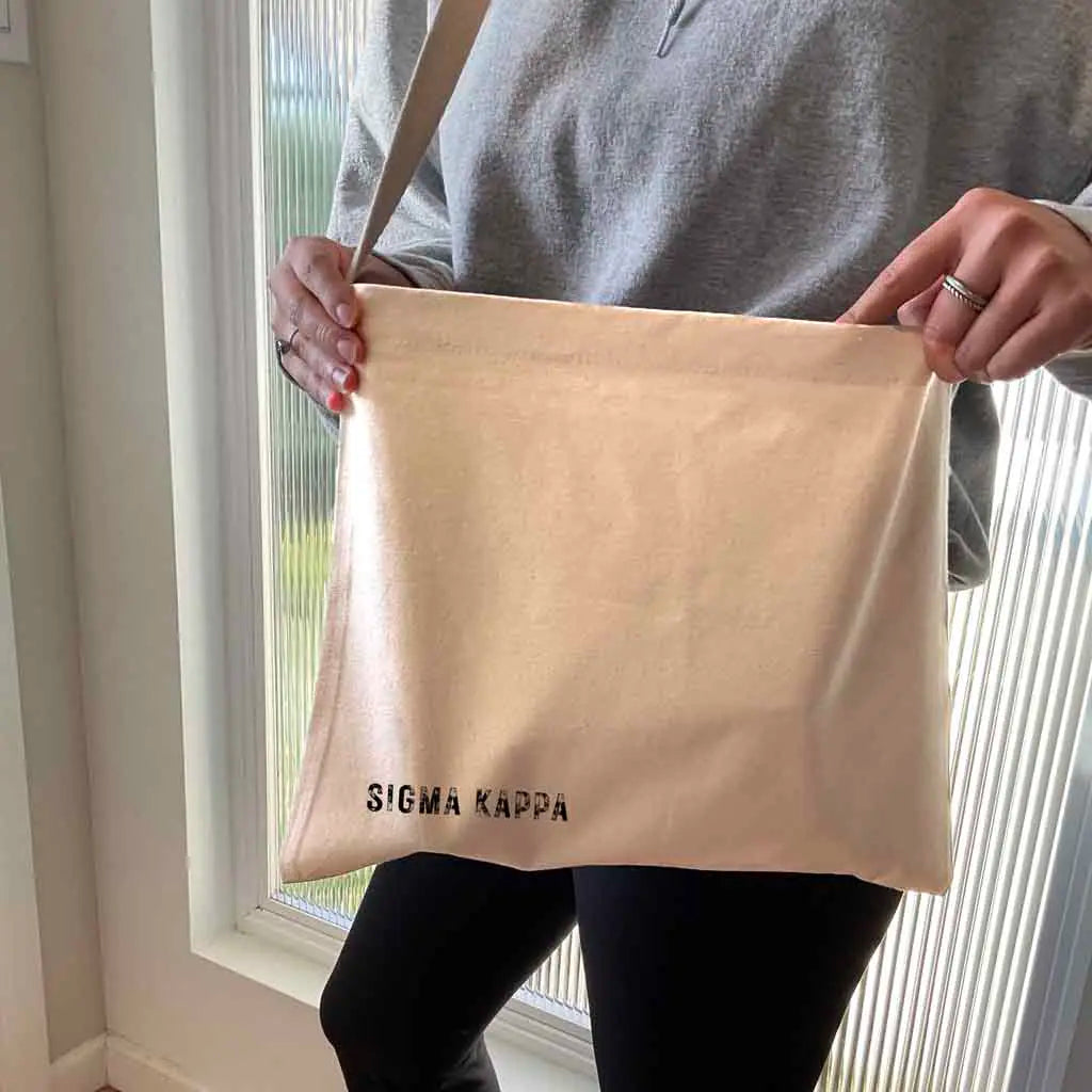 The design is permanently printed directly on the tote surface with eco-friendly water based apparel inks. We do not use vinyl stencils or iron-on patches that can fall off and the cotton canvas tote we use is extra large and durable too