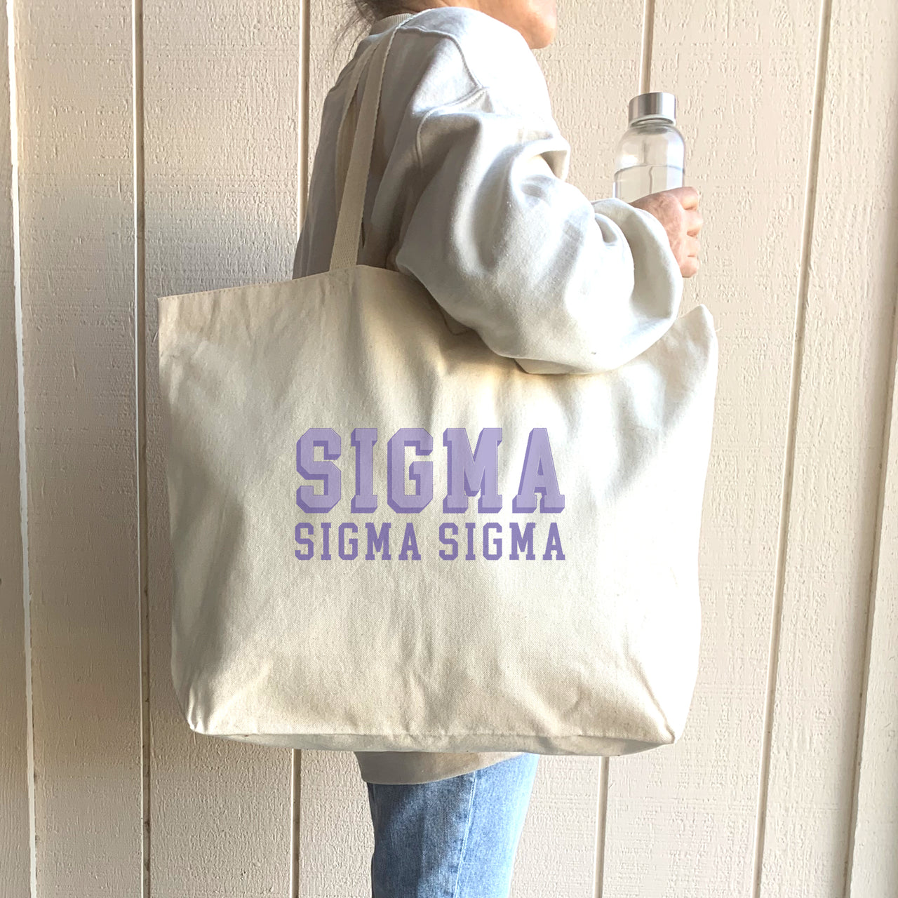 Sigma Sigma Sigma 3D letter tote shown on the shoulder of a casually dressed Tri Sigma woman.