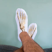 Skeleton foot socks with human foot bone anatomy printed across the top of each sock