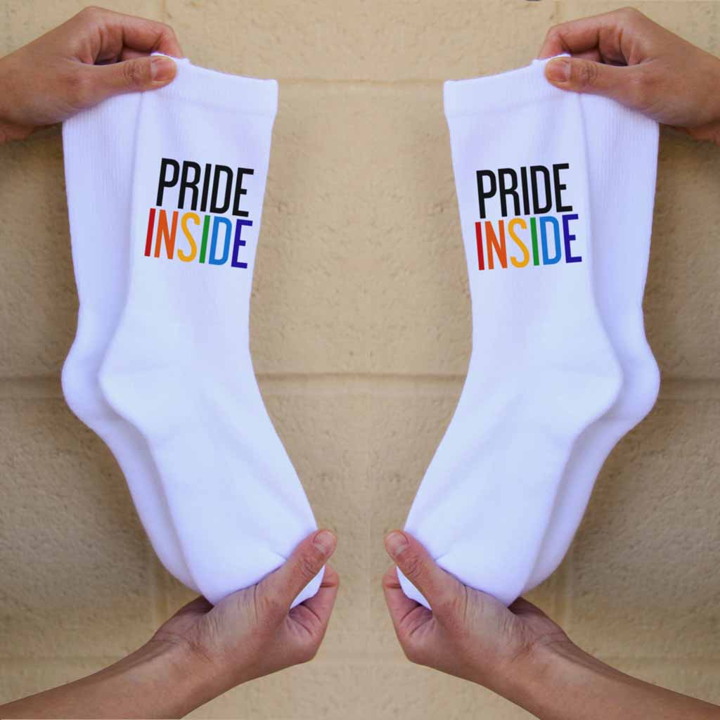 Pride inside rainbow letters custom printed on the outsides of comfy white cotton crew socks.