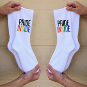 Pride inside rainbow letters custom printed on the outsides of comfy white cotton crew socks.