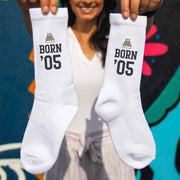 Born and your year design printed on white cotton crew socks with a gift wrap box included.