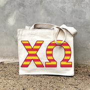 XO Black Stripe Tote in front of a gray wall