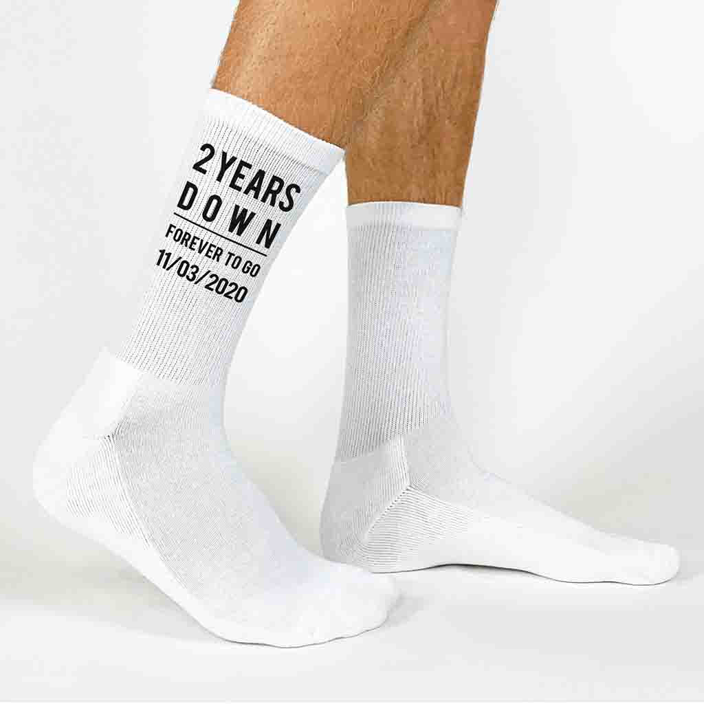 Two years down and forever to go is custom printed on the sides of the socks with the second anniversary socks as a cotton gift for men, personalized with your wedding date is a special gift for your loved one.