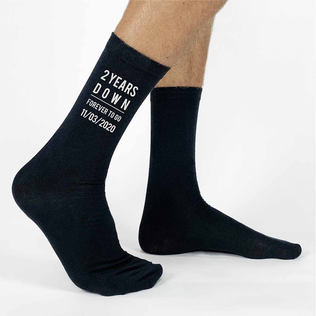 Two years down and forever to go is custom printed on the sides of the socks with the second anniversary socks as a cotton gift for men, personalized with your wedding date is a special gift for your loved one.