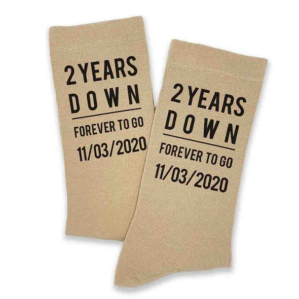 A pair of personalized second anniversary tan flat knit cotton dress socks as a cotton gift.