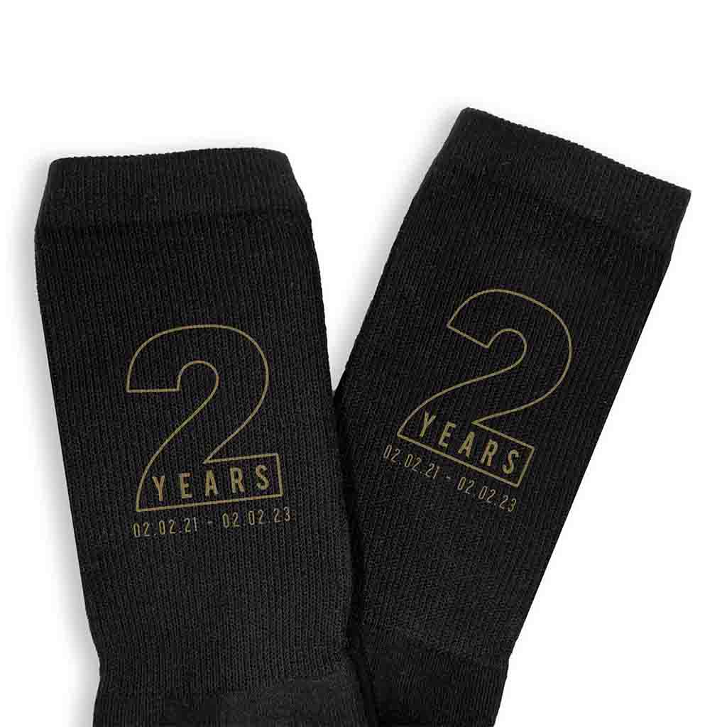 Personalized two year anniversary socks for your spouse with gold ink.