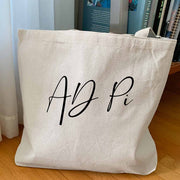 AD Pi sorority nickname digitally printed in script writing on canvas tote bag makes the perfect accessory for the college year.