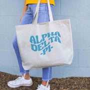 Alpha Delta Pi sorority name digitally printed on roomy canvas tote bag.