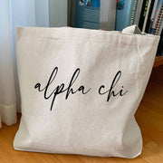Alpha Chi Omega sorority nickname custom printed in script writing on canvas tote bag is a unique gift for all your sorority sisters.