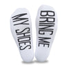 Bring me my shoes digitally printed in black ink on the bottoms of white cotton no show footie socks is a fun way to get your shoes when you don't want to get up.