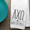 AXO sorority letters and name digitally printed in black ink boho style design on white cotton dishtowel.