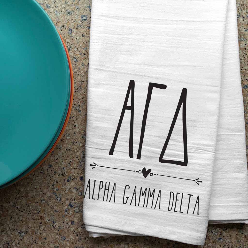 Alpha Gamma Delta sorority letters and name digitally printed in black ink boho style design on white cotton dishtowel.