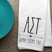 Alpha Sigma Tau sorority letters and name digitally printed in black ink boho style design on white cotton dishtowel.