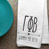 Gamma Phi Beta sorority letters and name digitally printed in black ink boho style design on white cotton dishtowel.