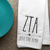 Zeta Tau Alpha sorority letters and name digitally printed in black ink boho style design on white cotton dishtowel.