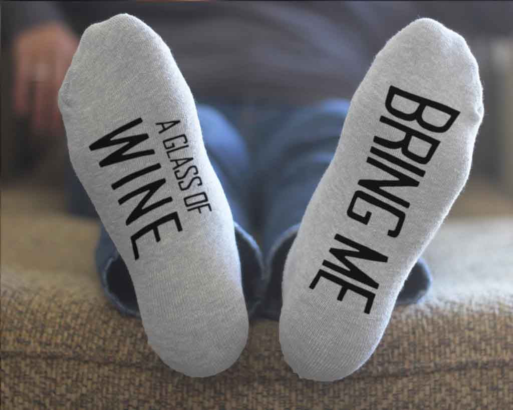 Bring me a glass of wine custom printed in black ink on the bottom soles of footie style no show socks make a fun night with your loved one.