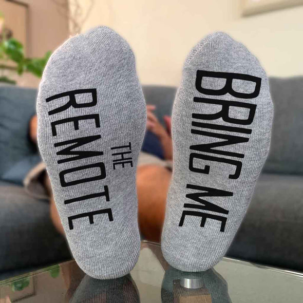 "Bring me the remote", custom printed on the bottom soles of the cotton footie no show socks, makes a great gift for your special someone.