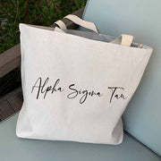 Alpha Sigma Tau sorority nickname digitally printed in script writing on canvas tote bag is the perfect accessory for your sorority sister.