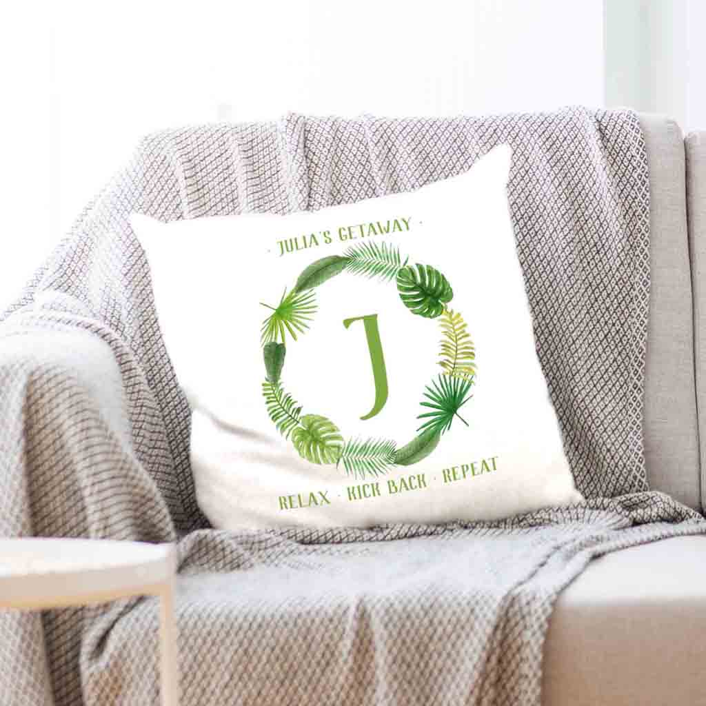 Throw pillow cover custom printed with a tropical leaf design and personalized with your name and monogram.