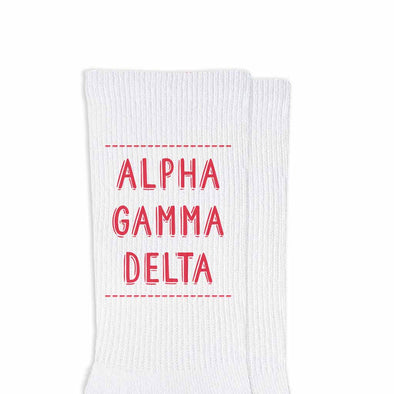 Alpha Gamma Delta sorority name in sorority color digitally printed on comfy white cotton crew socks.