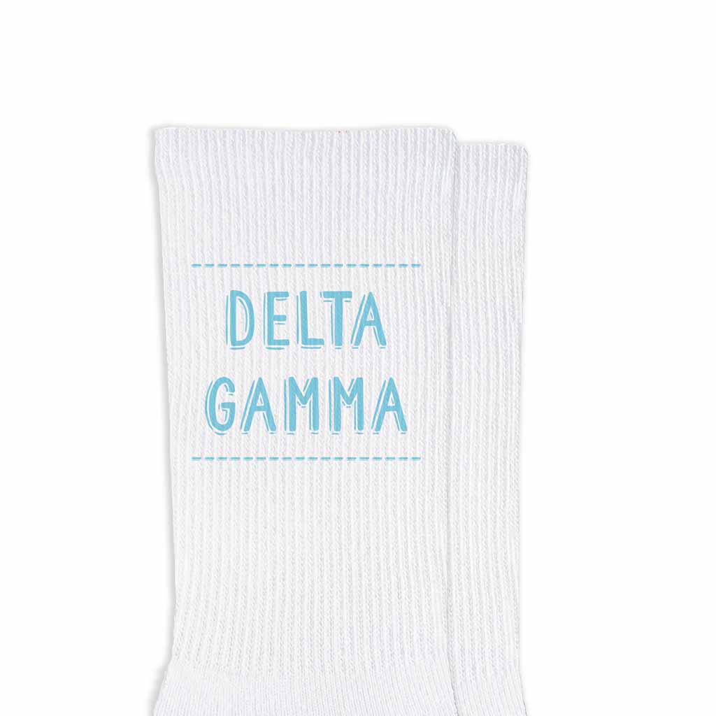 Delta Gamma sorority name design printed in sorority colors on comfy white cotton crew socks is the perfect gift for your sorority sisters.