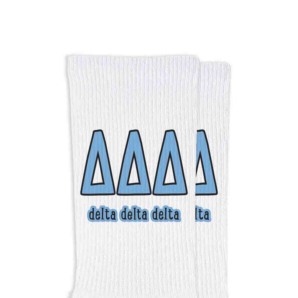 Tri Delta sorority letters and name digitally printed on white crew socks.